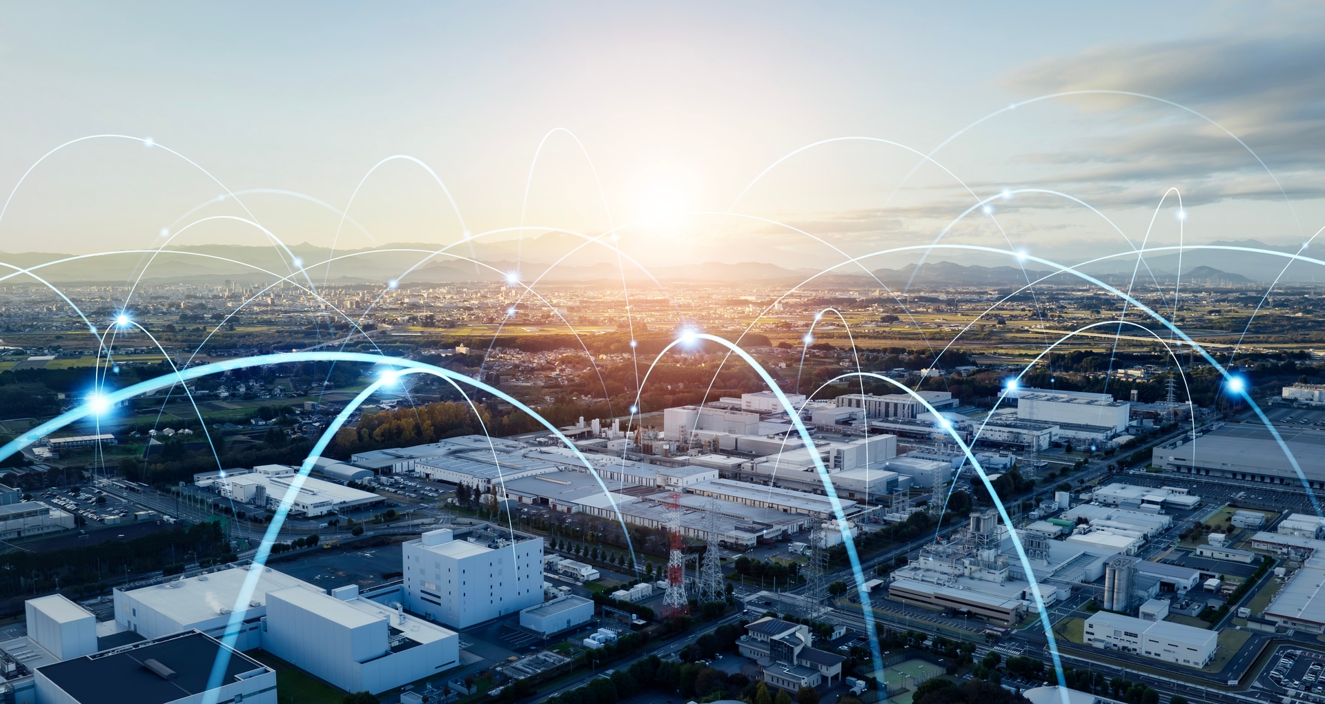 Aerial view of interconnected industrial facilities with digital connection lines, illustrating transparent procurement logistics